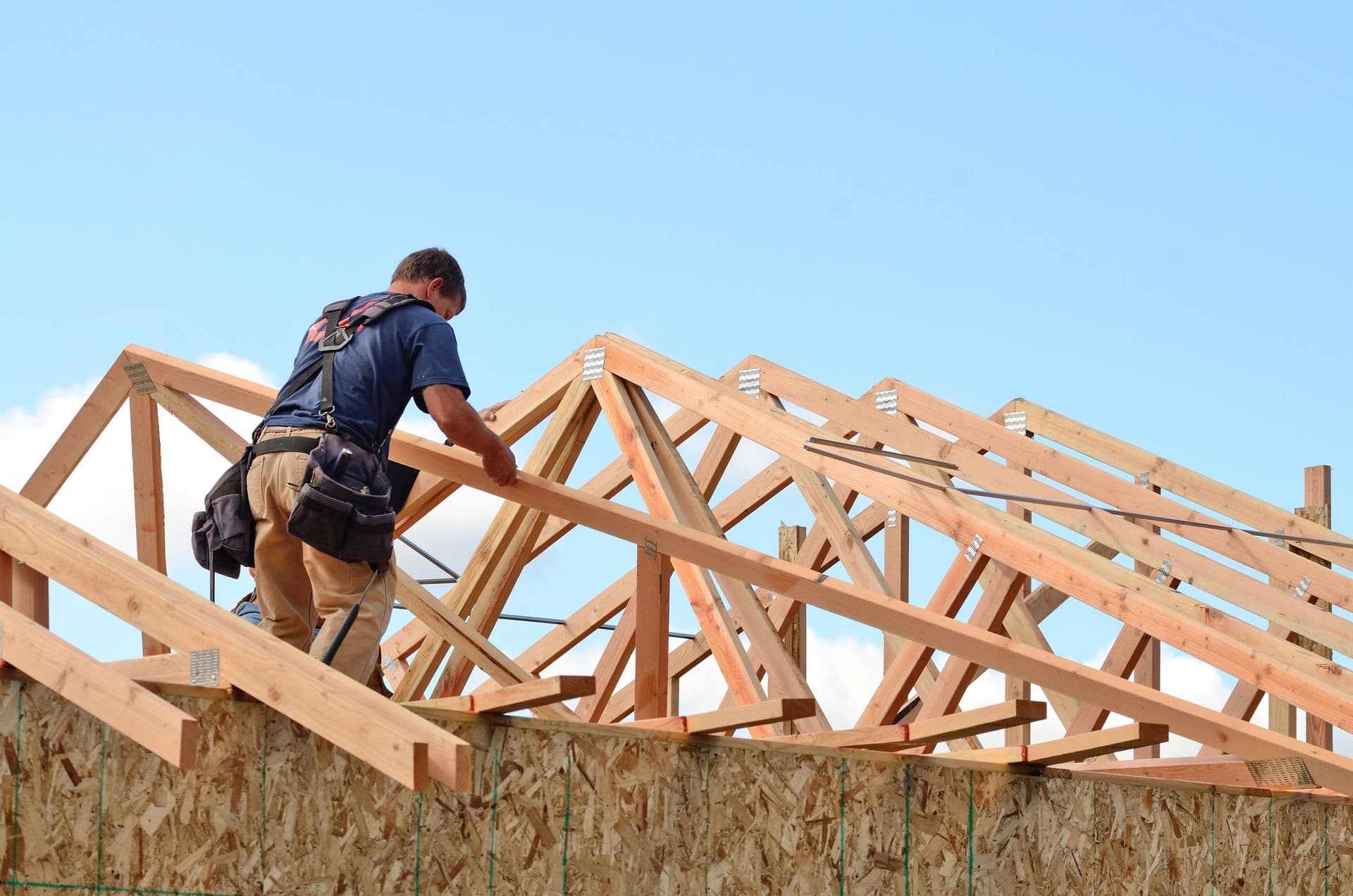 A crew member framing the roof of a new home
